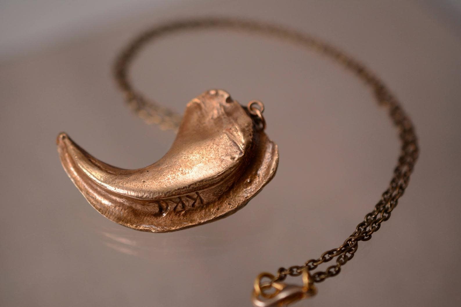 bronze lion claw replica pendant